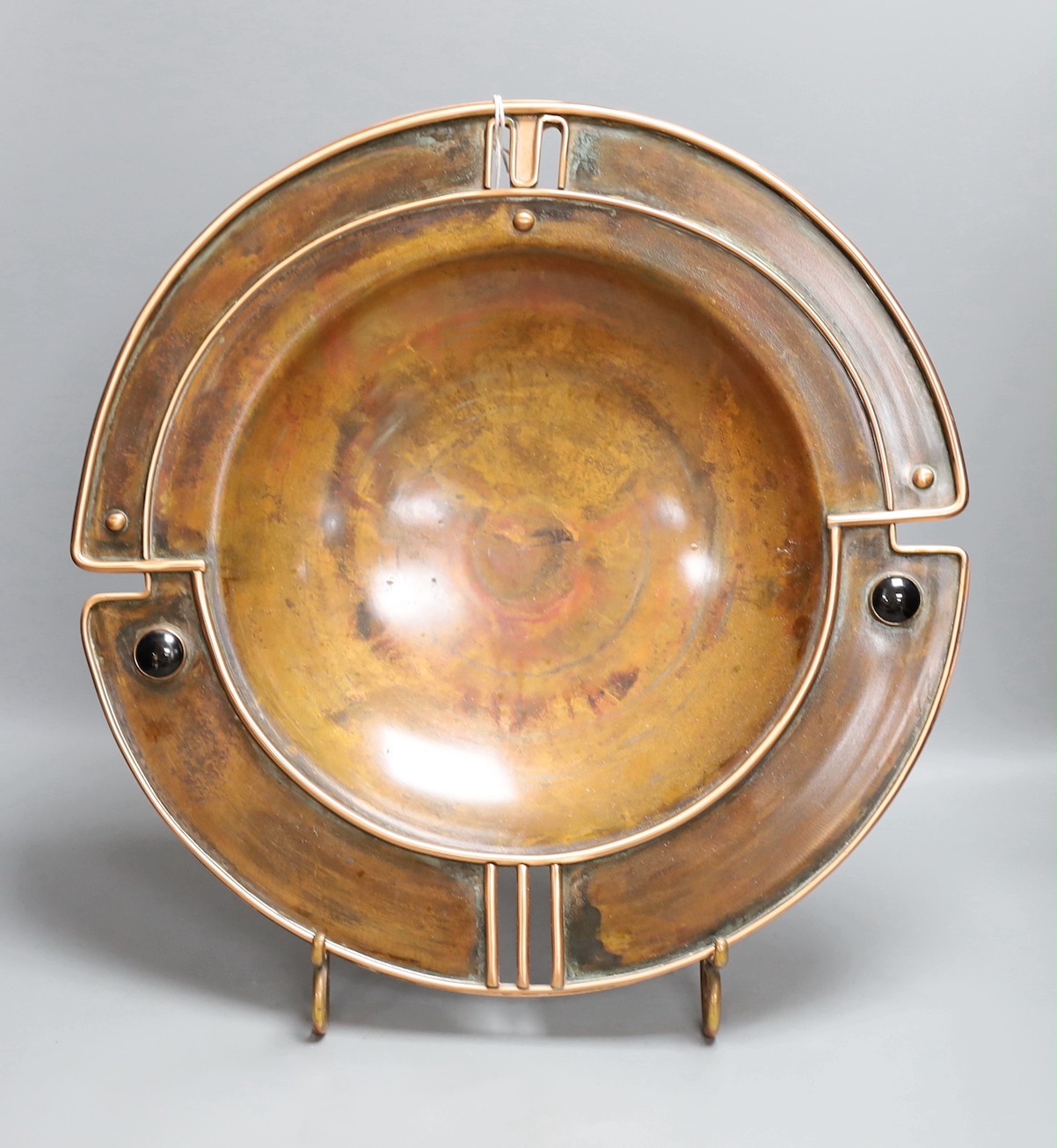 Sam Fanaroff - A large copper dish on stand, (Sussex Guild, West Ham, Pevensey), 45 cms diameter